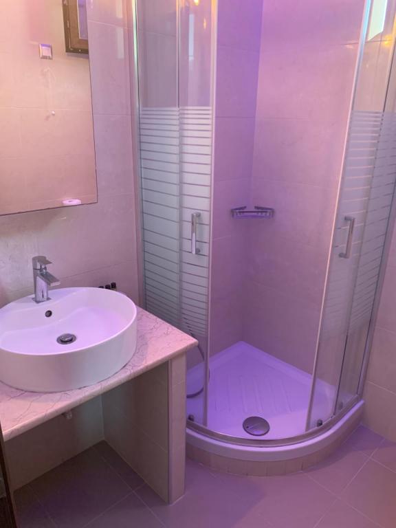 a bathroom with a shower and a sink and a shower at Vergos Hotel in Vourvourou