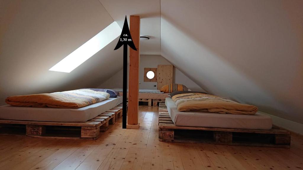 Ένα ή περισσότερα κρεβάτια σε δωμάτιο στο Luxusboofe - Ferienhaus am Lilienstein