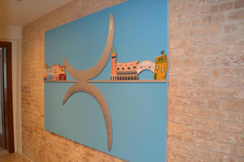 a wall with a shelf with houses on it at Ca' Bacio della Luna in Venice