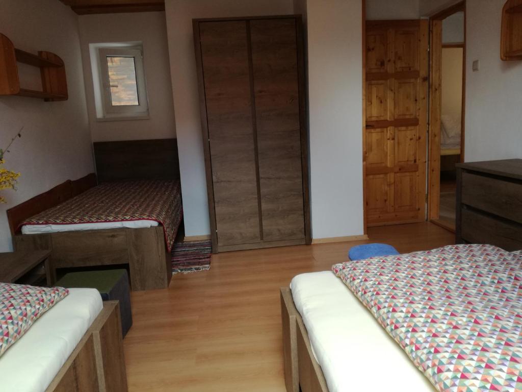 A bed or beds in a room at Apartmány Lenko - near thermal aquapark Tatralandia