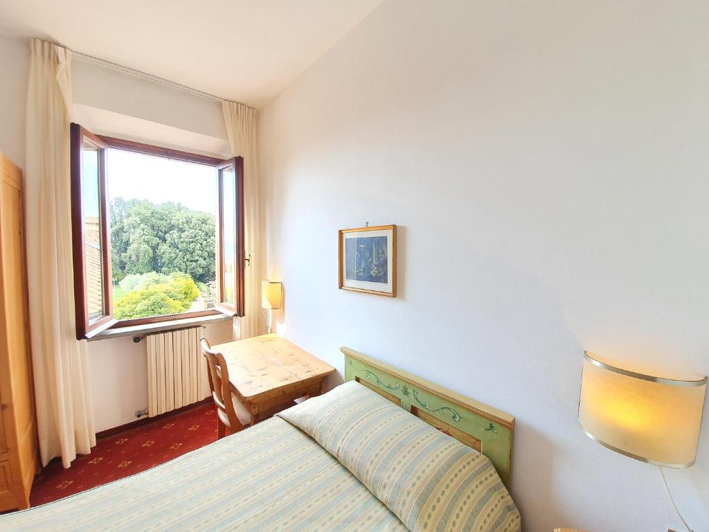 En eller flere senger på et rom på Villa Nencini