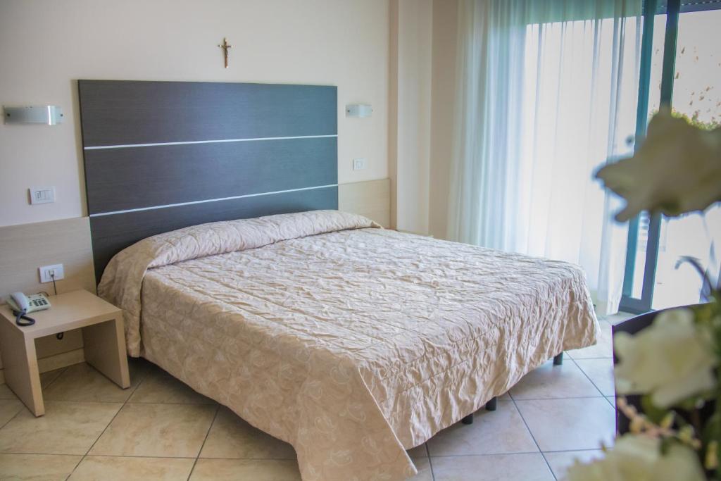 Postel nebo postele na pokoji v ubytování Renzo Hotel