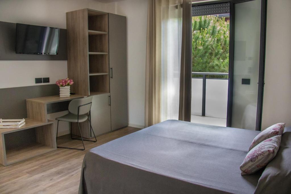 Postel nebo postele na pokoji v ubytování Renzo Hotel