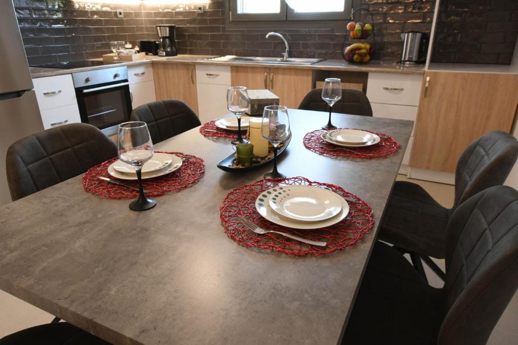 a table with glasses and plates on it in a kitchen at Orion Eco Suites in Karteros