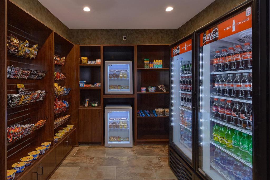 a grocery store aisle with a refrigerator and drinks at The Inn On The River in Pigeon Forge