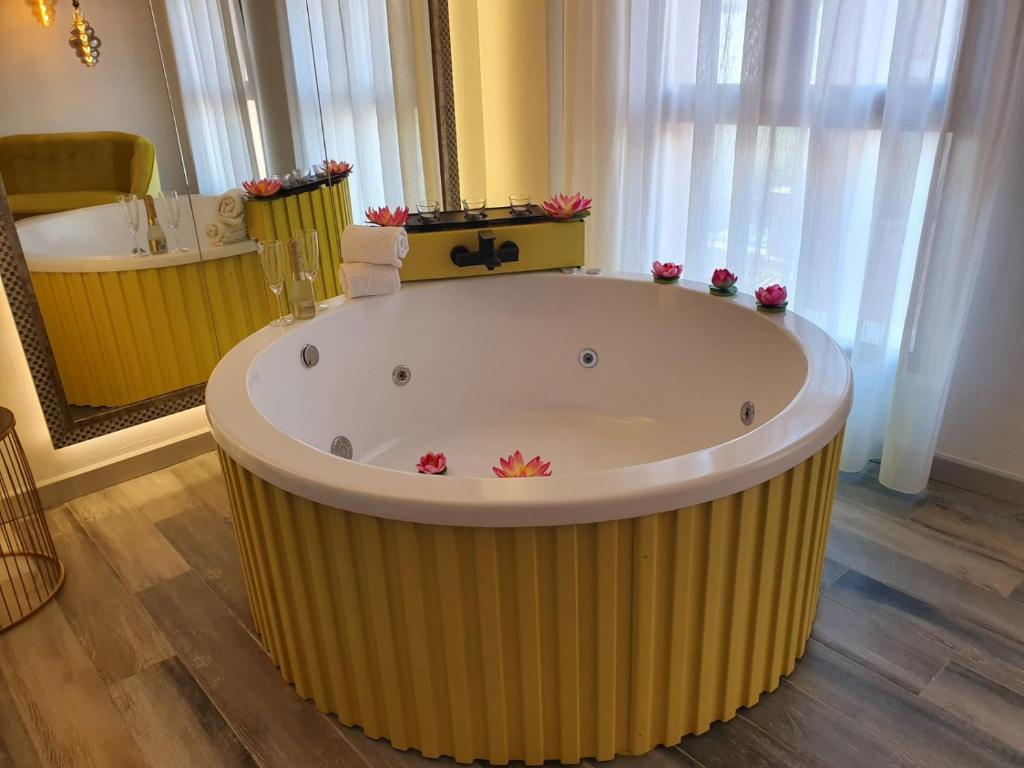 a large tub in a bathroom with a large mirror at Reina Victoria Prado Sastre in Alicante
