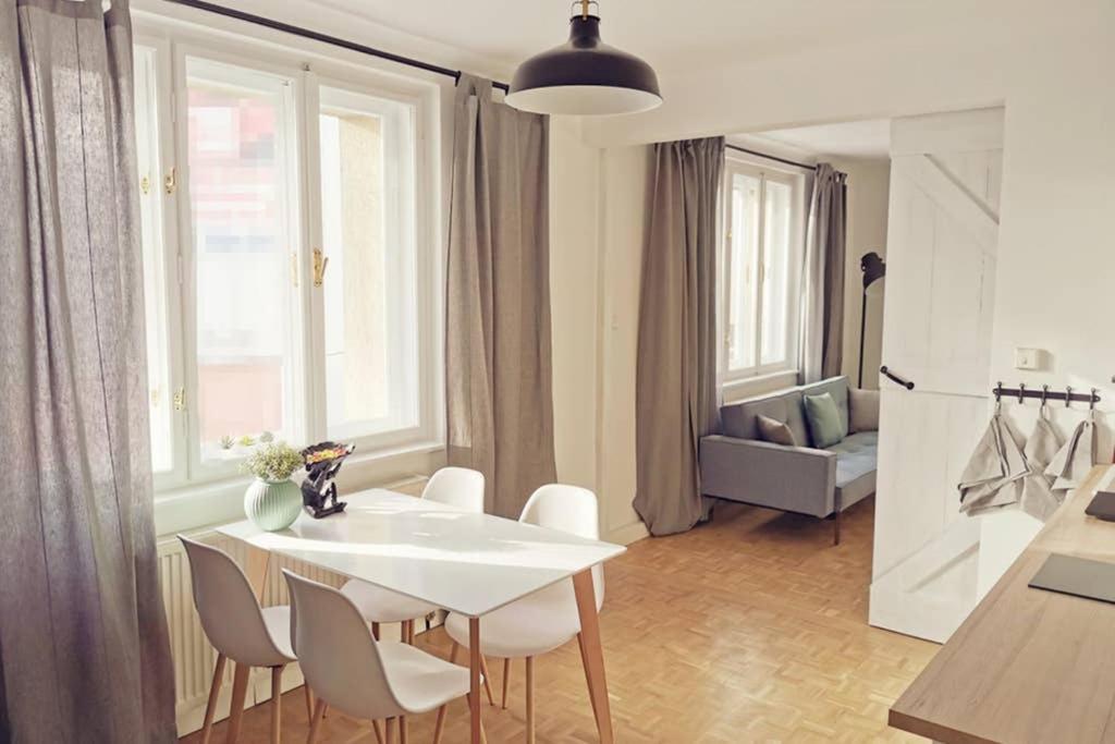 a kitchen and dining room with a white table and chairs at GORILLA - Central Station 100 meters away in Vienna