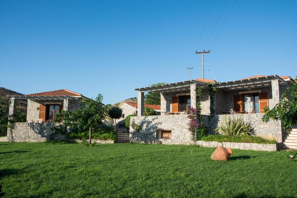 a house with a lawn in front of it at Filia Villas in Mirina
