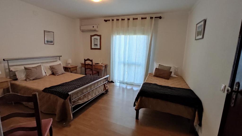 Postel nebo postele na pokoji v ubytování Residencial Do Rita em Rio Caldo