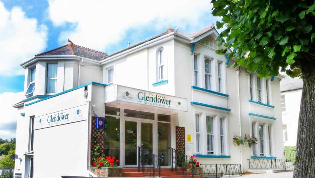 a white building with a store in front of it at Glendower in Torquay