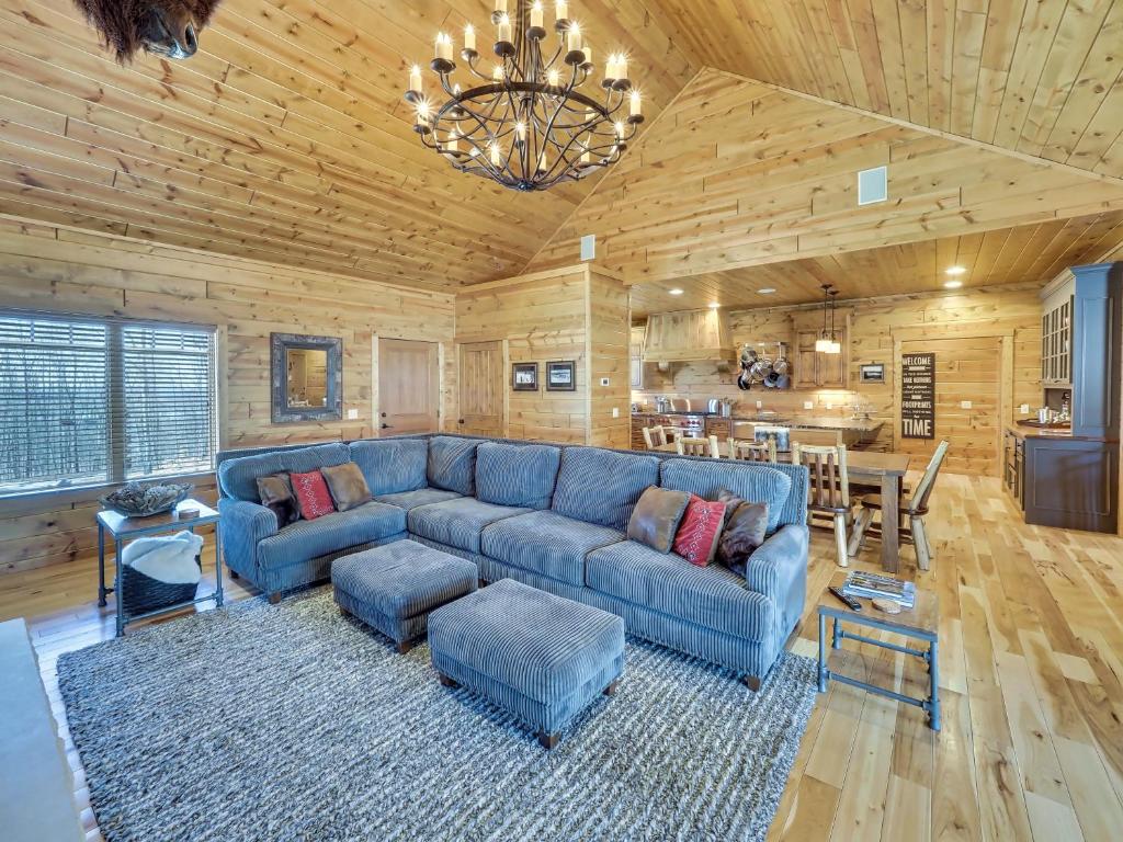 a living room with a blue couch and a table at Wee-Kin-Da-Wa in Boyne Falls