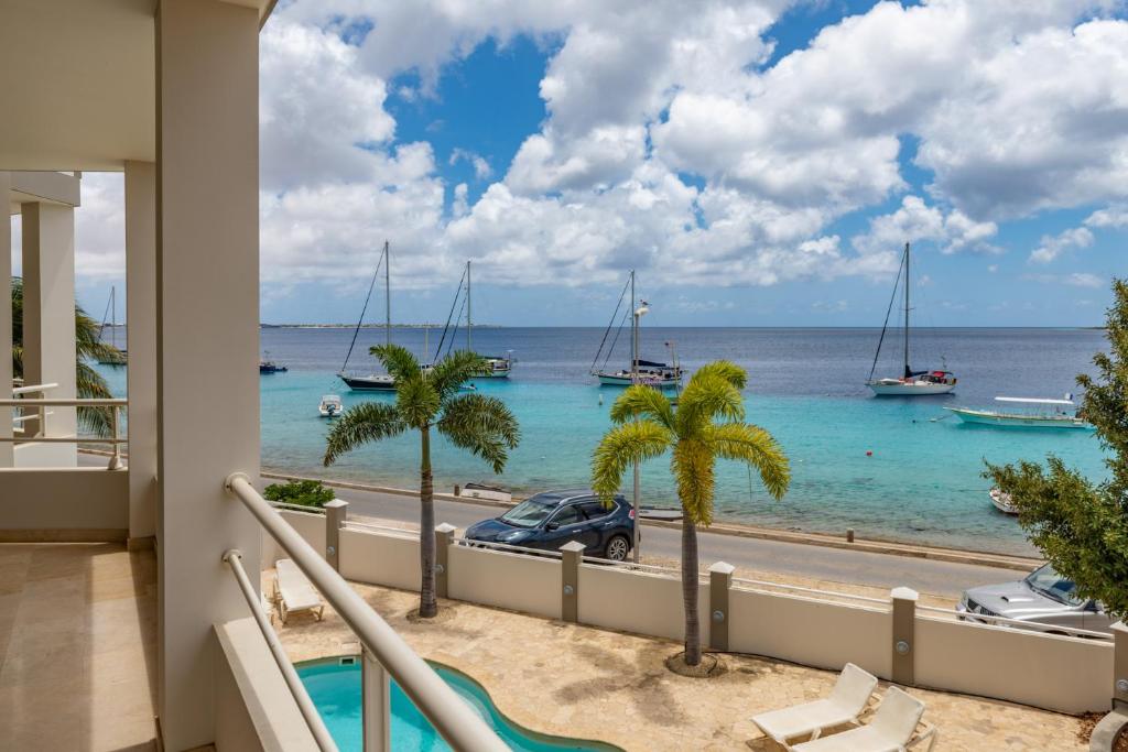 a view of the ocean from the balcony of a house at Seaside Queen Suite in Kralendijk