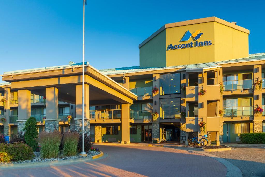 um grande edifício amarelo com um sinal nele em Accent Inns Kamloops em Kamloops