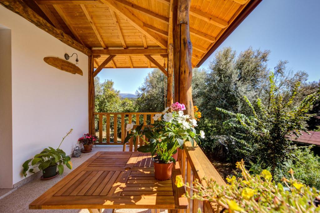 a wooden deck with potted plants on it at Casa da Eira "Lavoura da Bouça - Fruta Bio" in Celorico de Basto