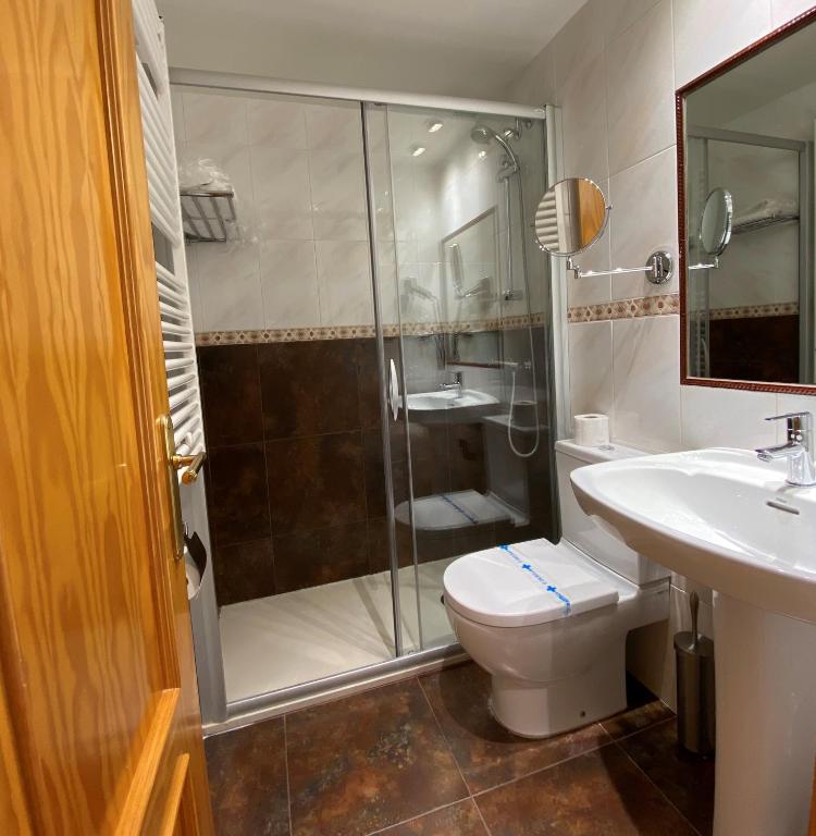 Un baño con ducha, inodoro y lavabo. en Hotel Casa Custodio, en La Puebla de Roda