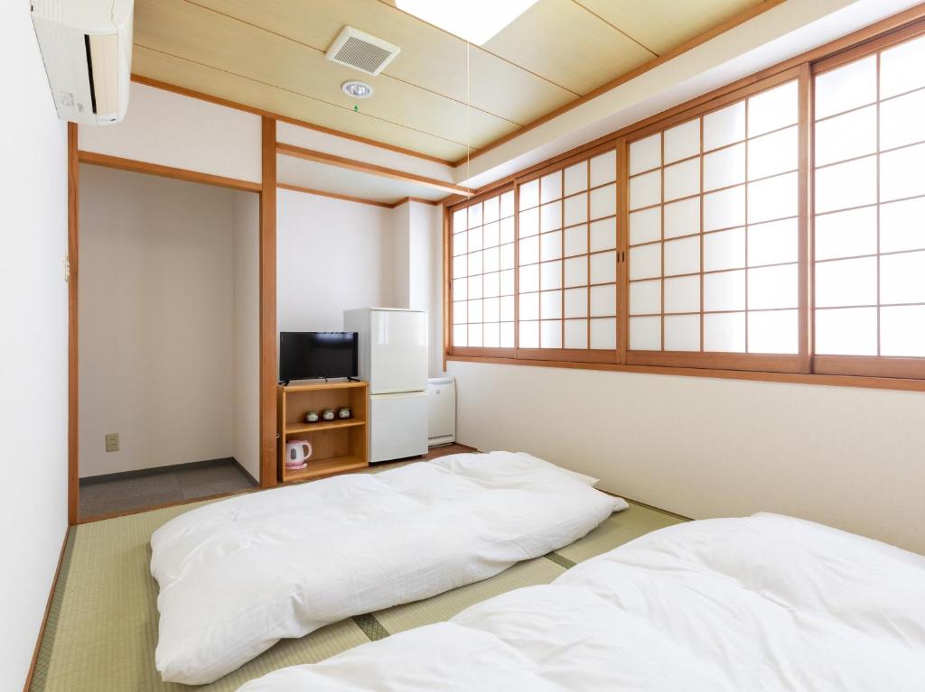 Postel nebo postele na pokoji v ubytování Tabist Hotel Yuan Akashi
