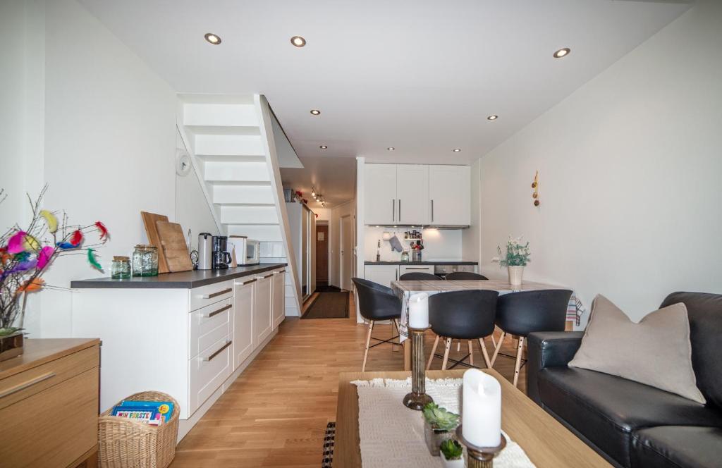 a kitchen and living room with a couch and a table at Private Apartment close to Sirdal Hotel in Tjørhom