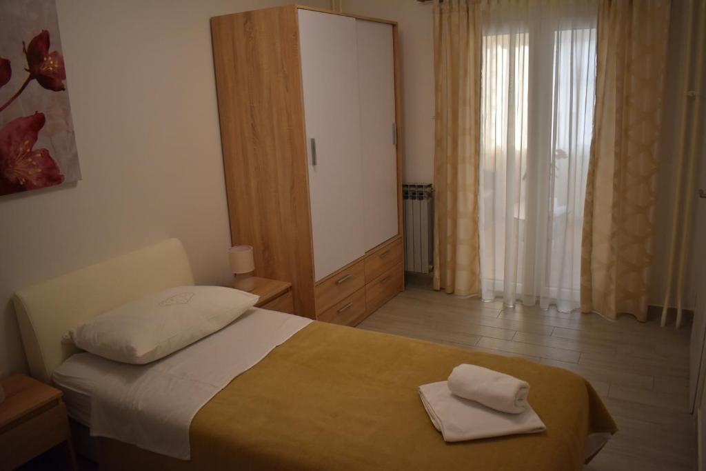 Postel nebo postele na pokoji v ubytování Korcula Apartments Iliskovic