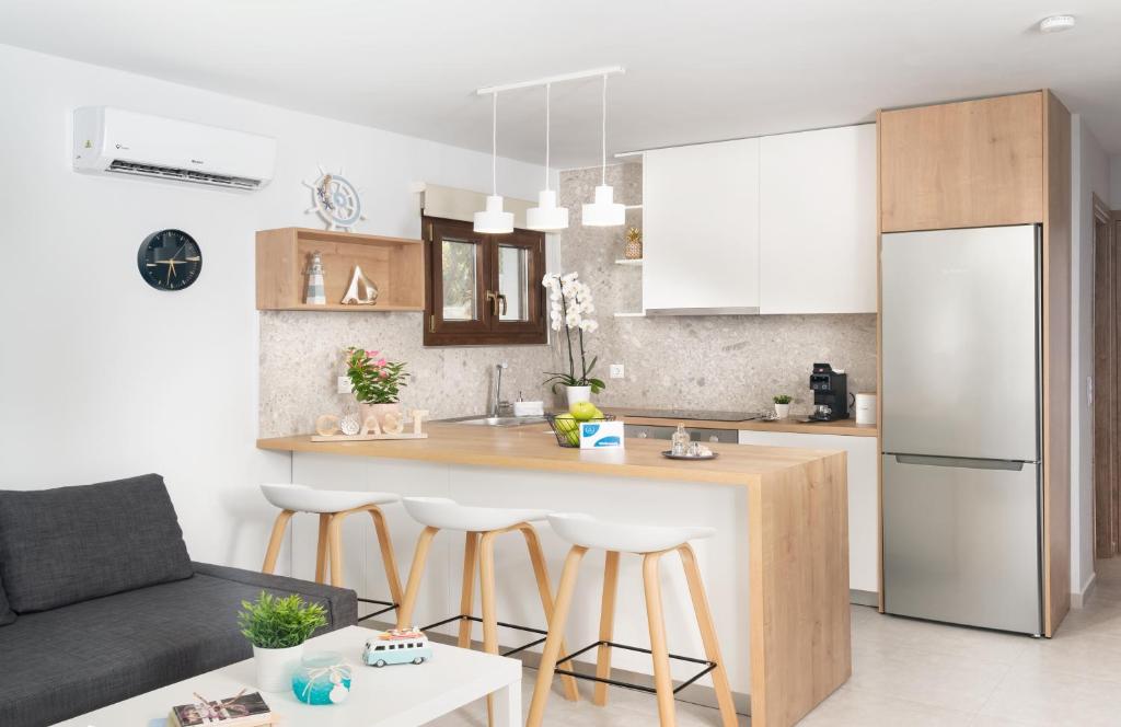 a kitchen with a kitchen island in a room at Blue Coast Garden Apartments in Hersonissos