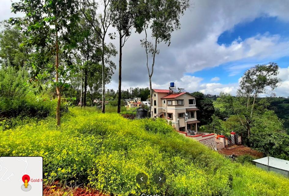 a house sitting on top of a grassy hill at Gold Nest Valley View 3BHK (3DAYS MINI. STAY) in Panchgani