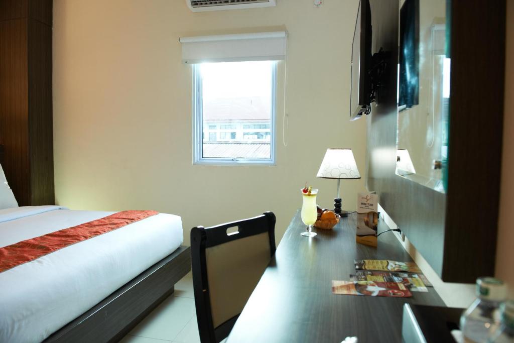 Postel nebo postele na pokoji v ubytování Winstar Hotel