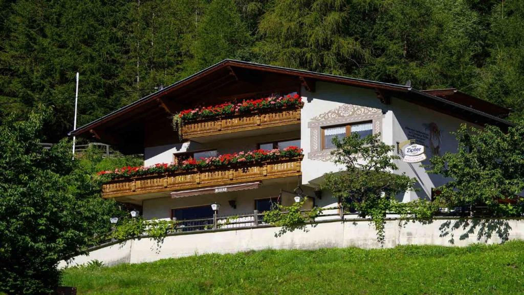 a house with flower boxes on the side of it at Pension Riese in Neustift im Stubaital