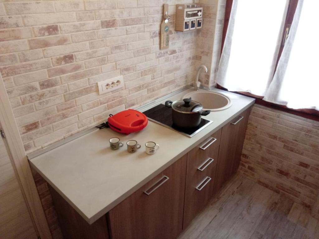 a small bathroom with a sink and a counter at Alghero Old Town Apartment in Alghero