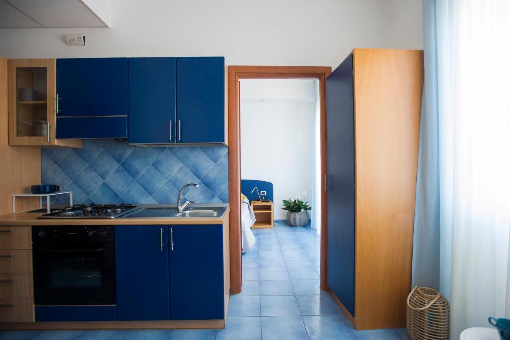 a kitchen with blue cabinets and a sink at Residence Panoramic in Maiori