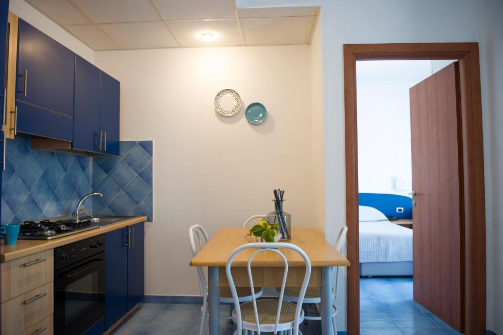 a kitchen with a table and chairs in a room at Residence Panoramic in Maiori
