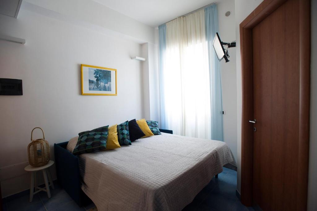a bedroom with a bed and a window at Residence Panoramic in Maiori