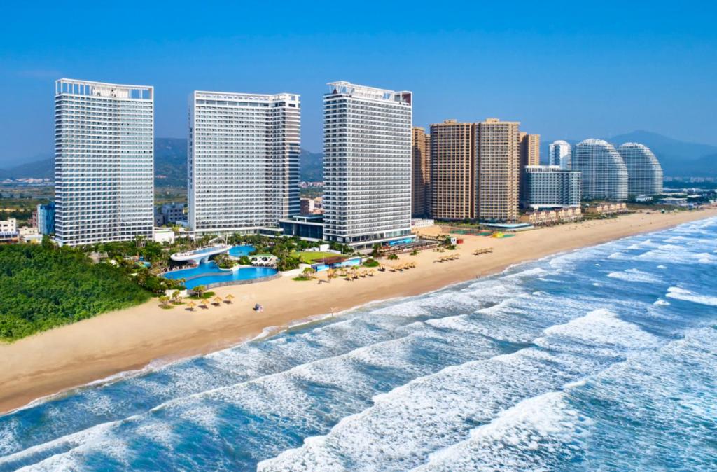 an aerial view of a beach with tall buildings at Dusit Thani Shuangyue Bay Resort Huizhou in Huidong