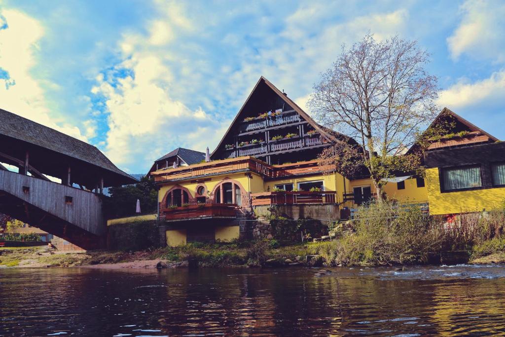 a house sitting on the side of a river at Das Waldhaus in Forbach
