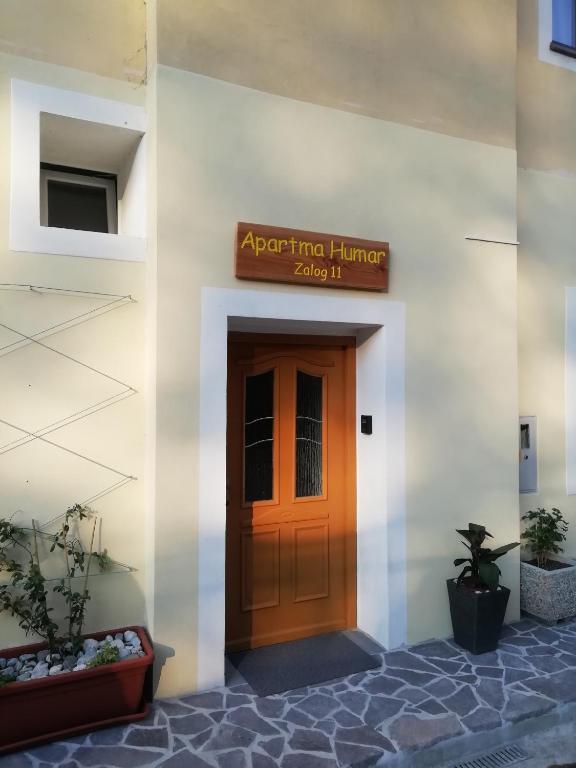 a front door of a building with a sign above it at Apartma Humar in Tolmin
