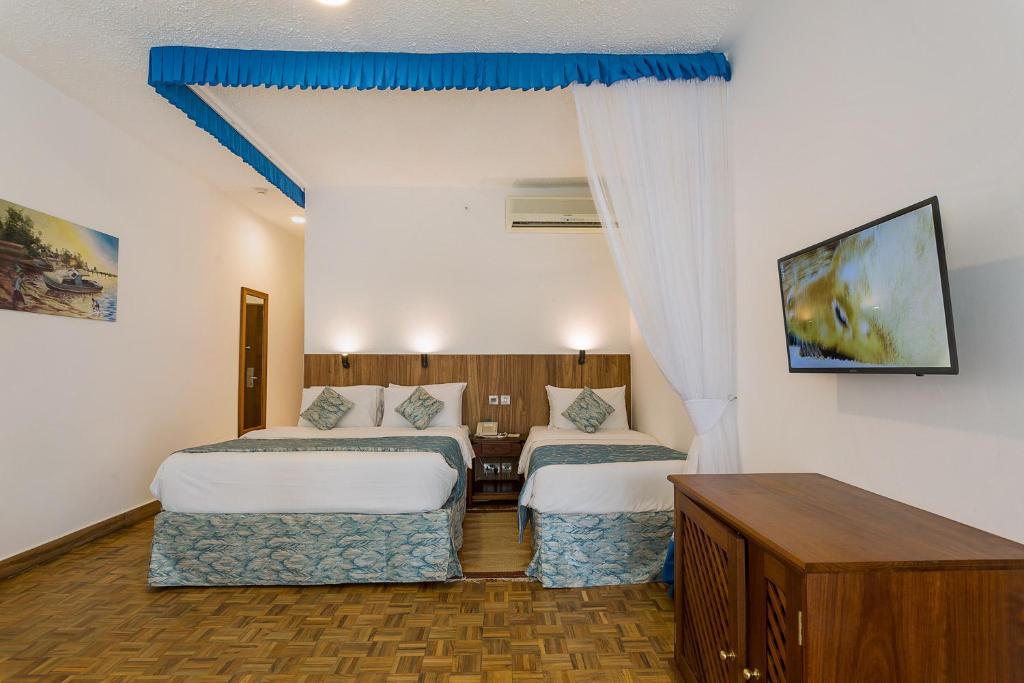 Krevet ili kreveti u jedinici u objektu Travellers Beach Hotel