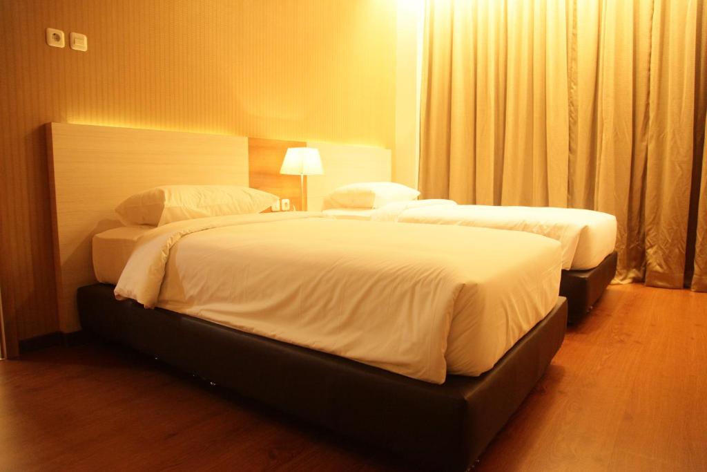 Postel nebo postele na pokoji v ubytování Winstar Hotel