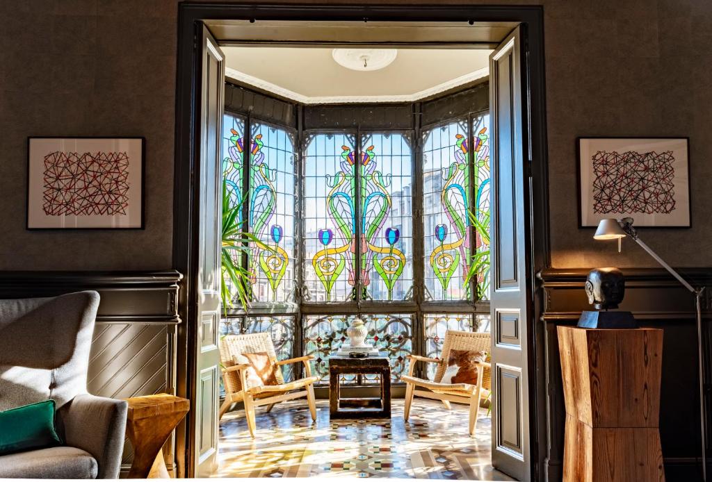 a living room with a stained glass window at SuiteaBCN in Barcelona