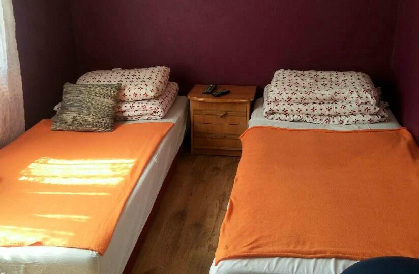 two twin beds in a room with at MHostel in Piaseczno