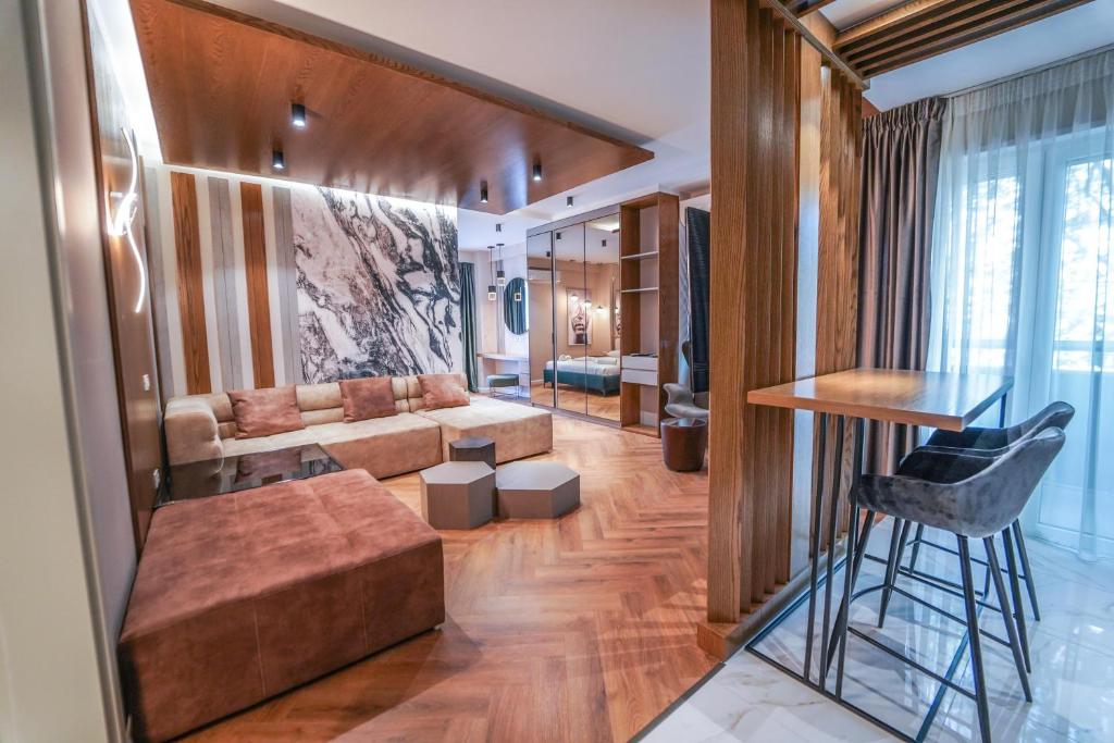 a living room with a couch and a table at Haris Luxury Apartment no.4 in Tirana