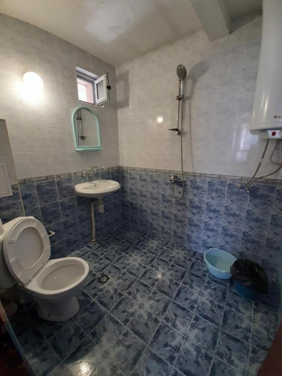 a bathroom with a toilet and a sink at Guest House Damyanov in Ravda