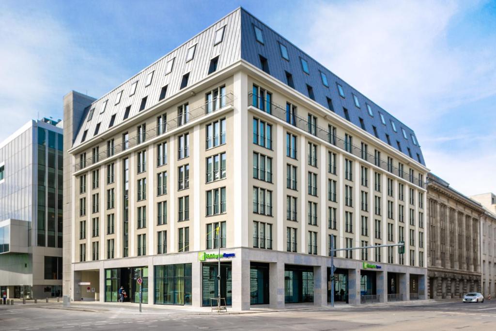 a large white building on a city street at Holiday Inn Express - Berlin - Alexanderplatz, an IHG Hotel in Berlin