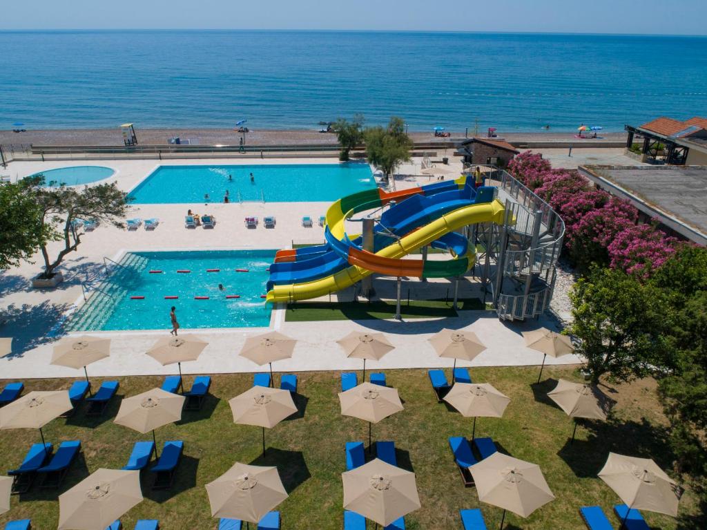 an overhead view of a swimming pool with a water slide at Pearl Beach Hotel & Resort in Čanj