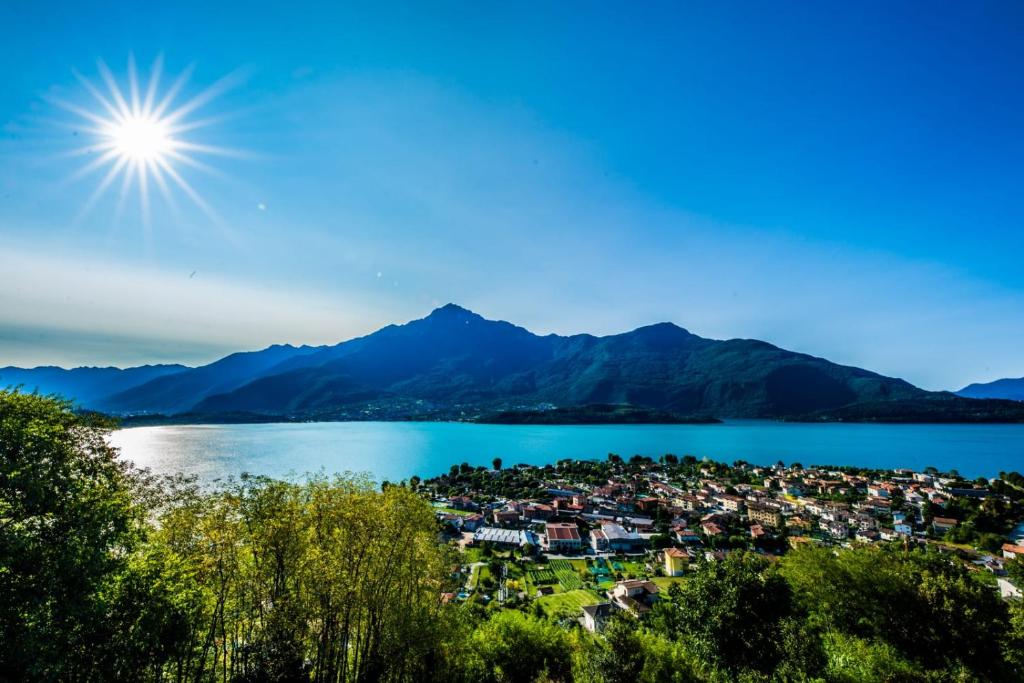 a town on the shore of a lake with mountains in the background at B&B Da Melissa in Vercana