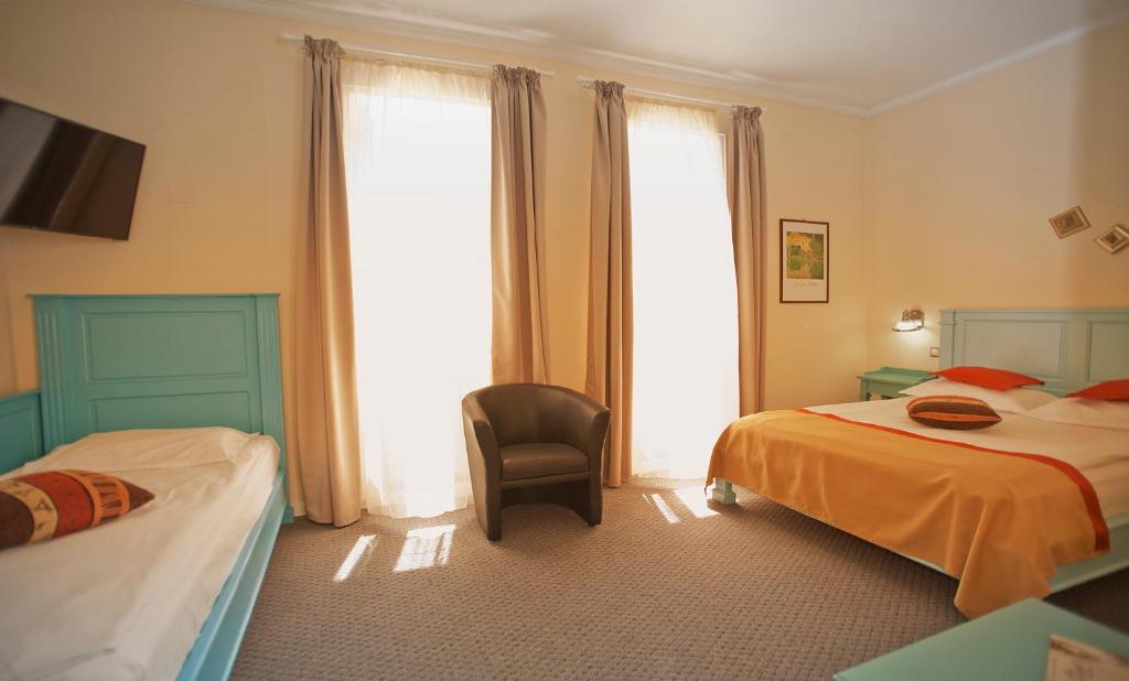 Postel nebo postele na pokoji v ubytování Hotel Bastion