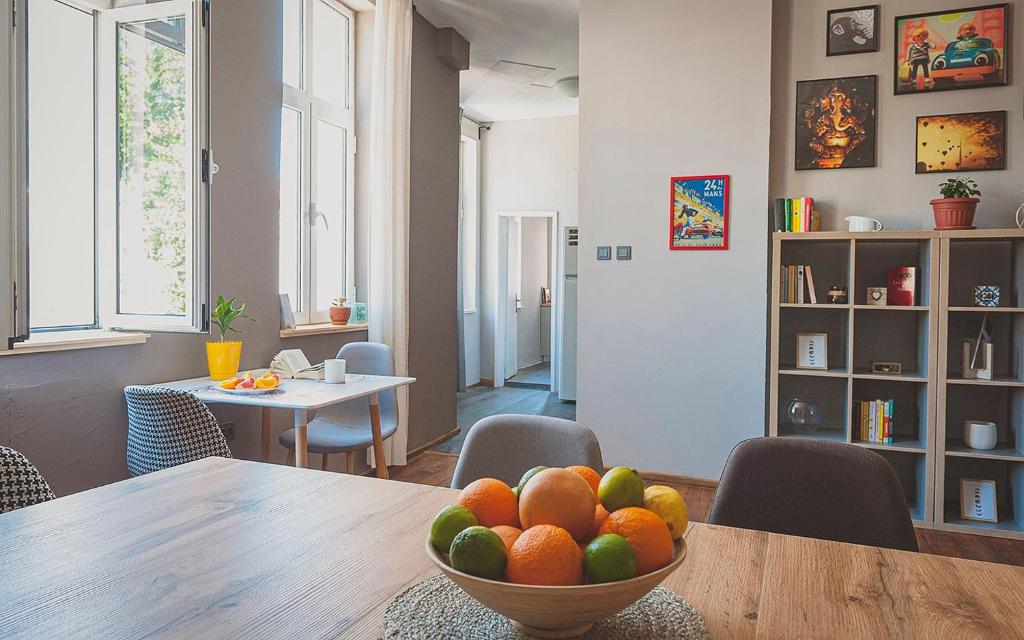 a dining room with a bowl of fruit on a table at Temple House in Plovdiv