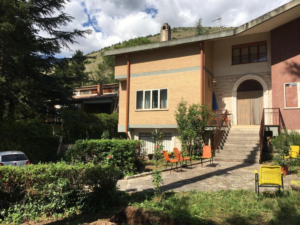 a house with chairs sitting outside of it at VILLA OLGA in Cese