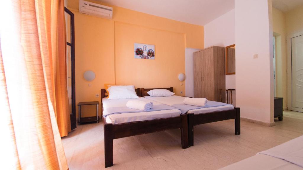 a bedroom with a bed with two pillows on it at Blue Ippokampos in Pefkohori