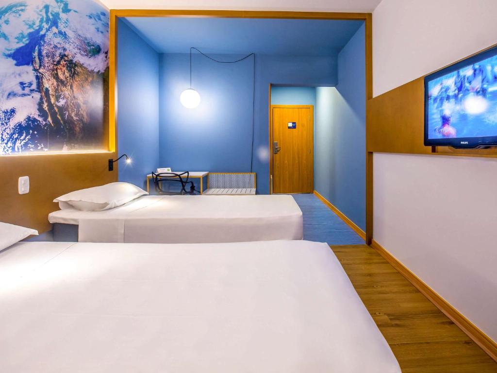 Postel nebo postele na pokoji v ubytování Hotel Euro Suite Curitiba Batel By Nacional Inn