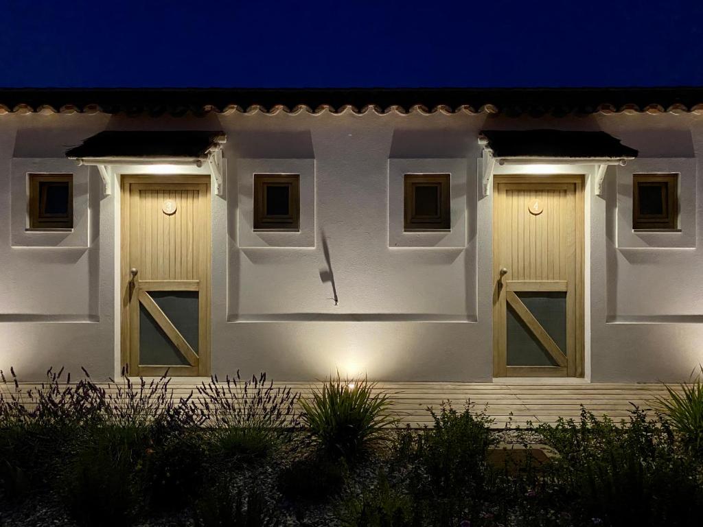 a white house with two doors at night at Hortas do Rio - Casa de Campo in Carrapateira