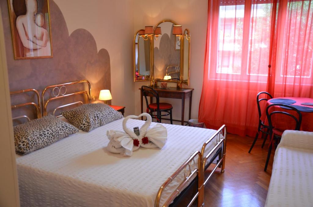 a bedroom with a white bed with a bow on it at B&B Villa Olmo in Como