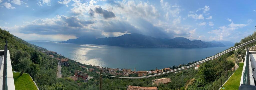 a view of a large body of water with mountains at Appartamenti vista lago in Castelletto di Brenzone